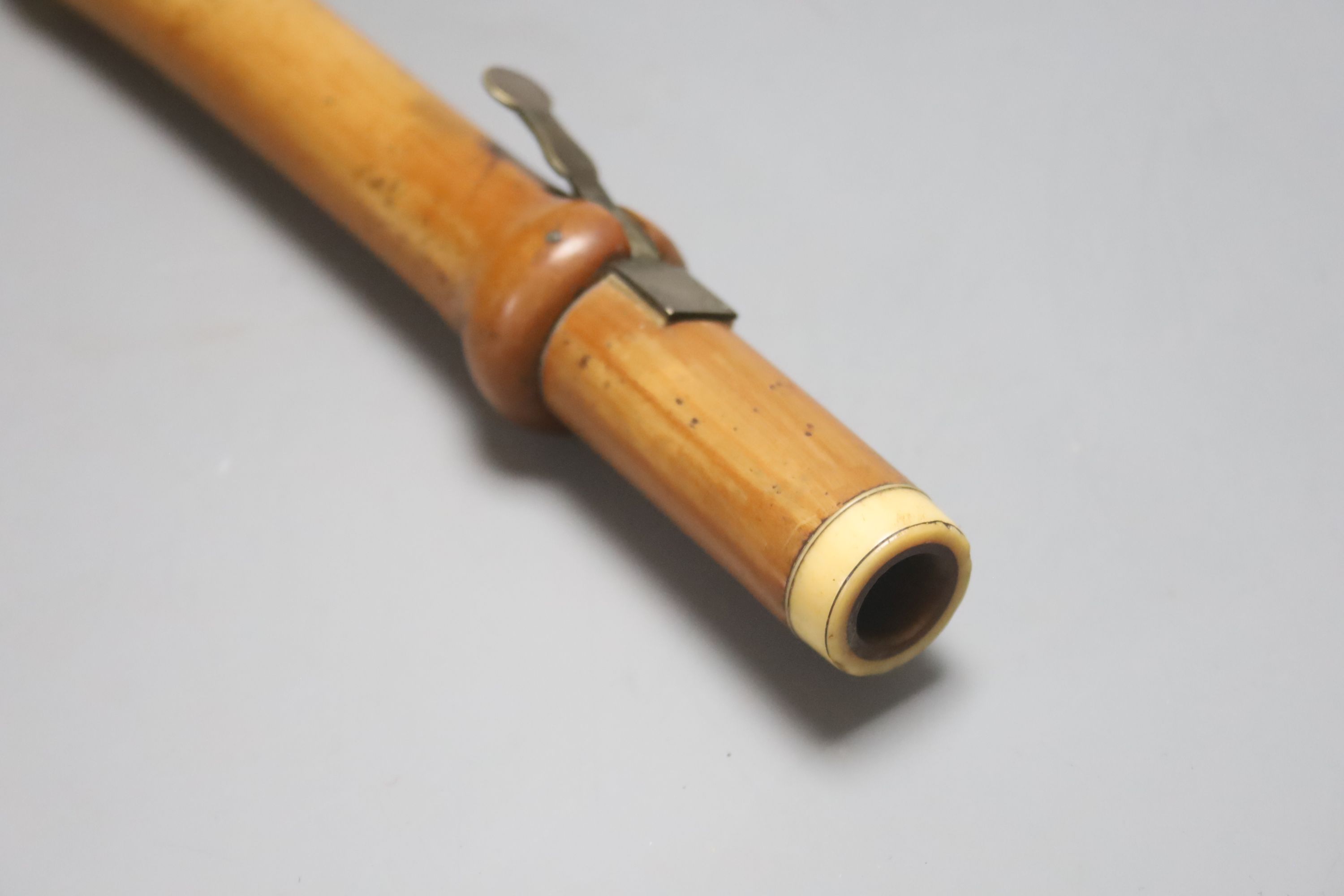 A three sectional Monzani flute with seven holes and a turned ivory cap and collars, stamped Monzari, Old Bona St , London, 19th centur